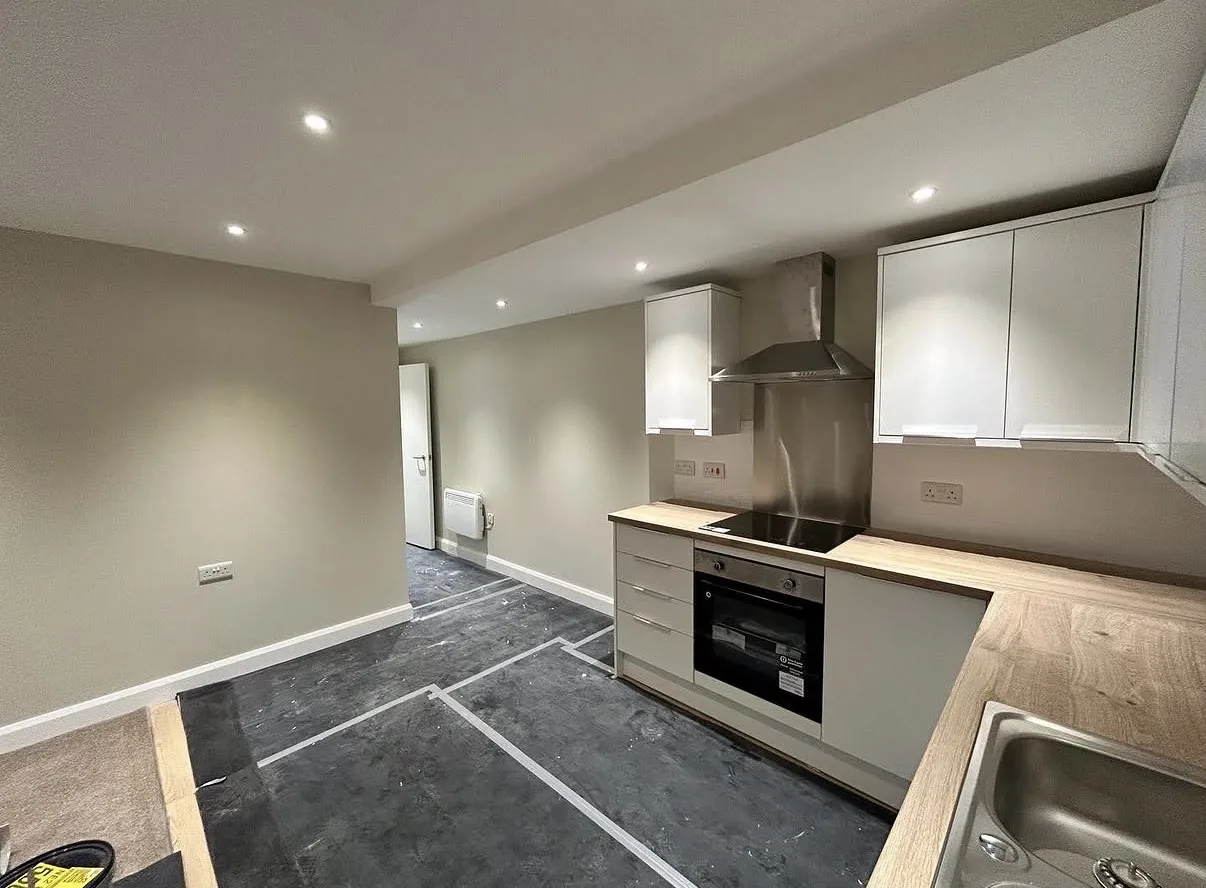 Completed kitchen with fitted units after plastering and decoration